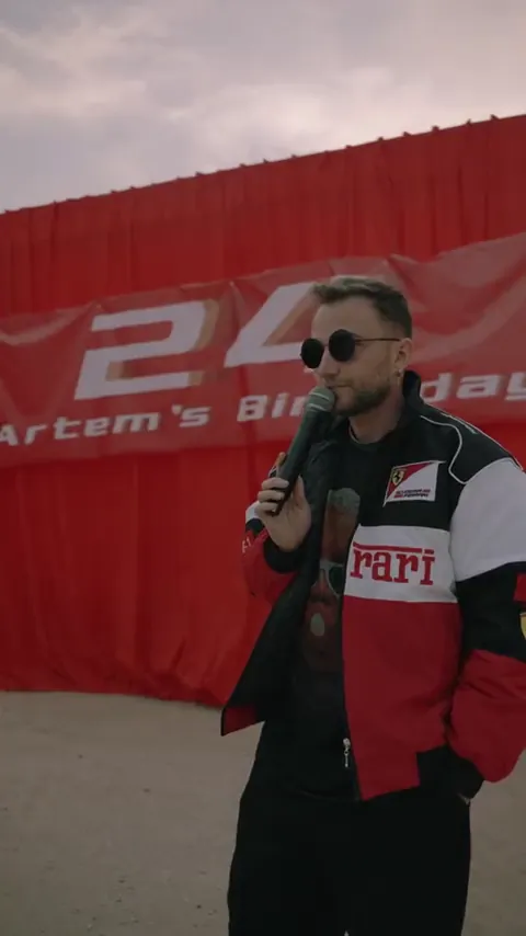 Host with a microphone at a racing-themed party