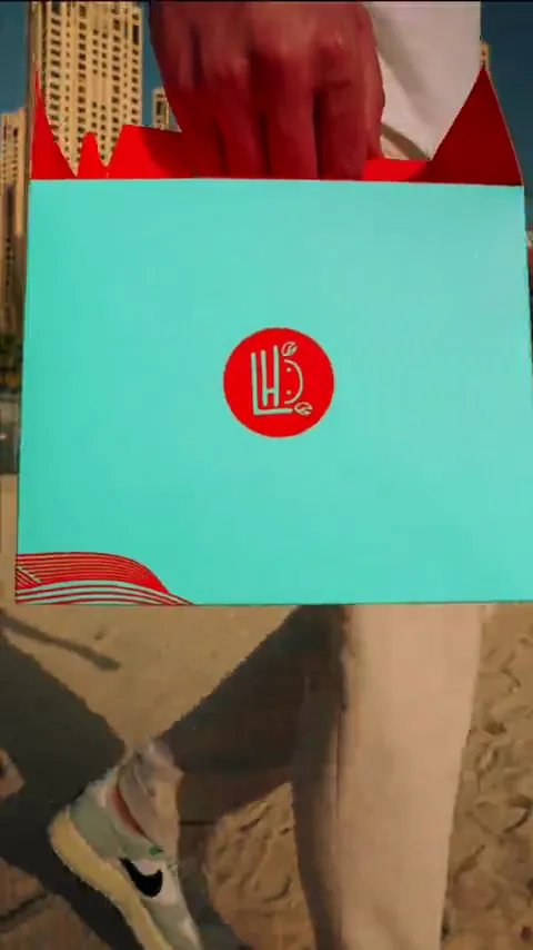 Branded turquoise takeaway box carried through the city