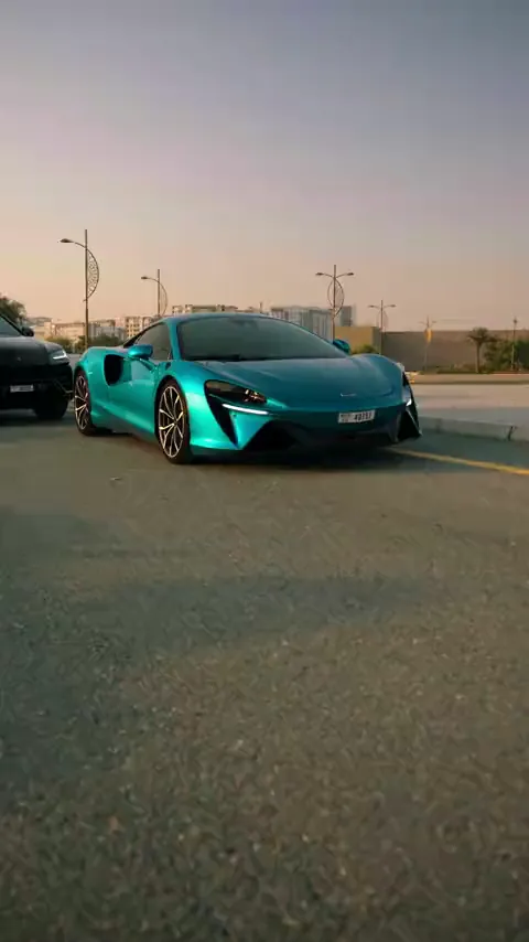 Turquoise supercar on an empty road at golden hour