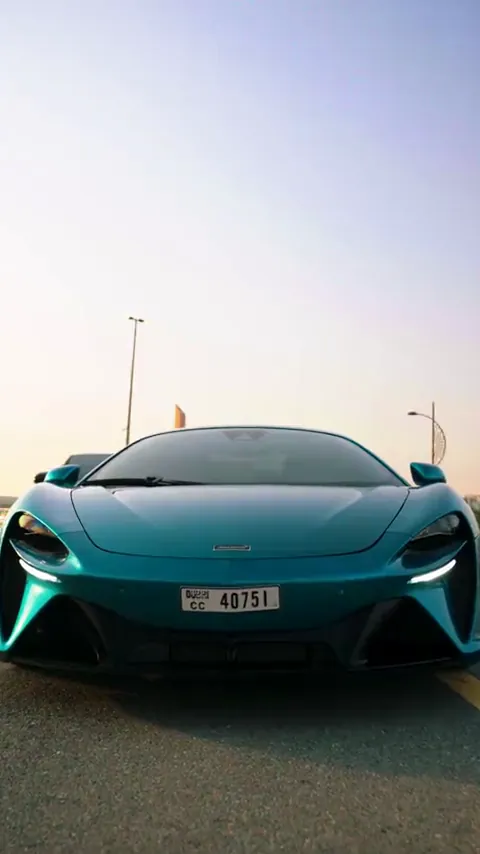 Front view of a turquoise supercar with LED lights