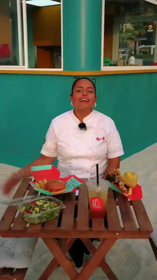 Chef presenting dishes at an outdoor restaurant table