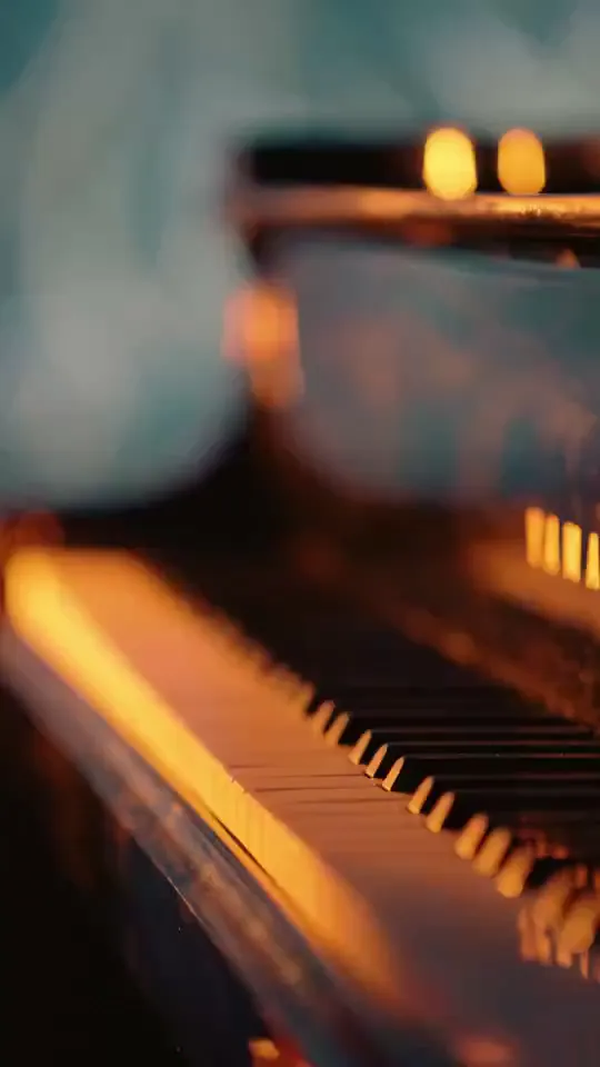 Candle-lit grand piano keys in close-up
