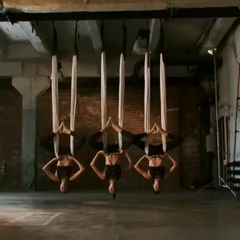 Aerial yoga class in an industrial studio