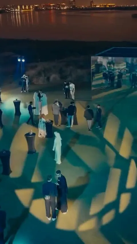 Evening waterfront reception with projected patterns