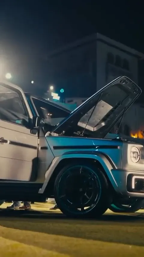 Off-road SUV with doors open on display at night
