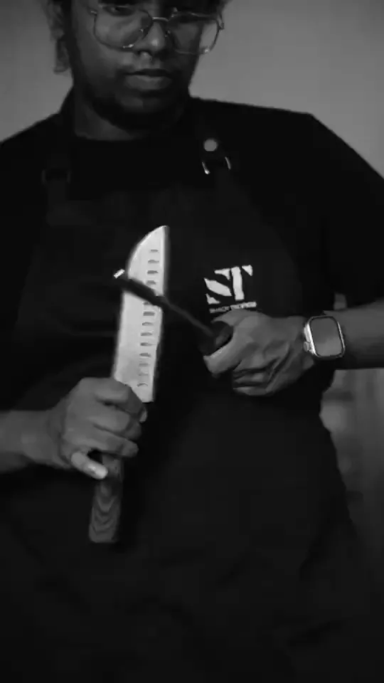 Chef holding a knife, black-and-white portrait