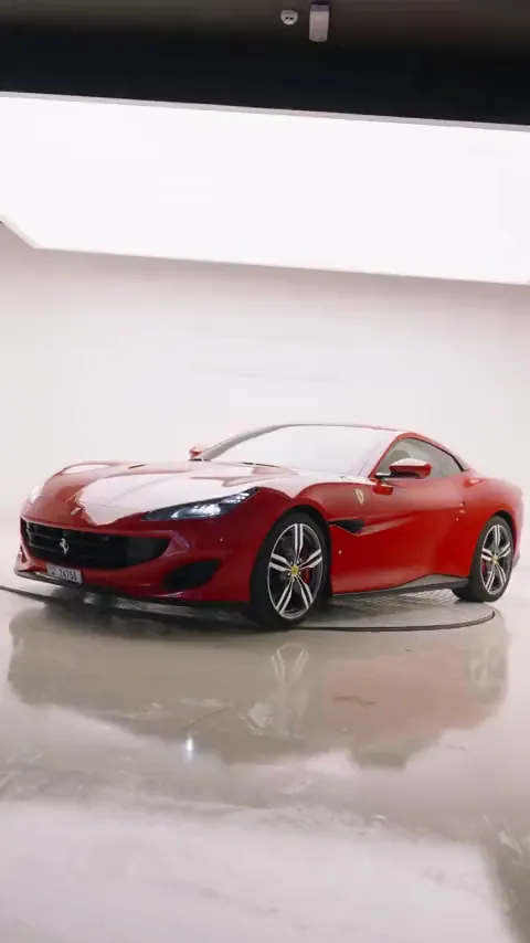 Red sports car on a white showroom turntable